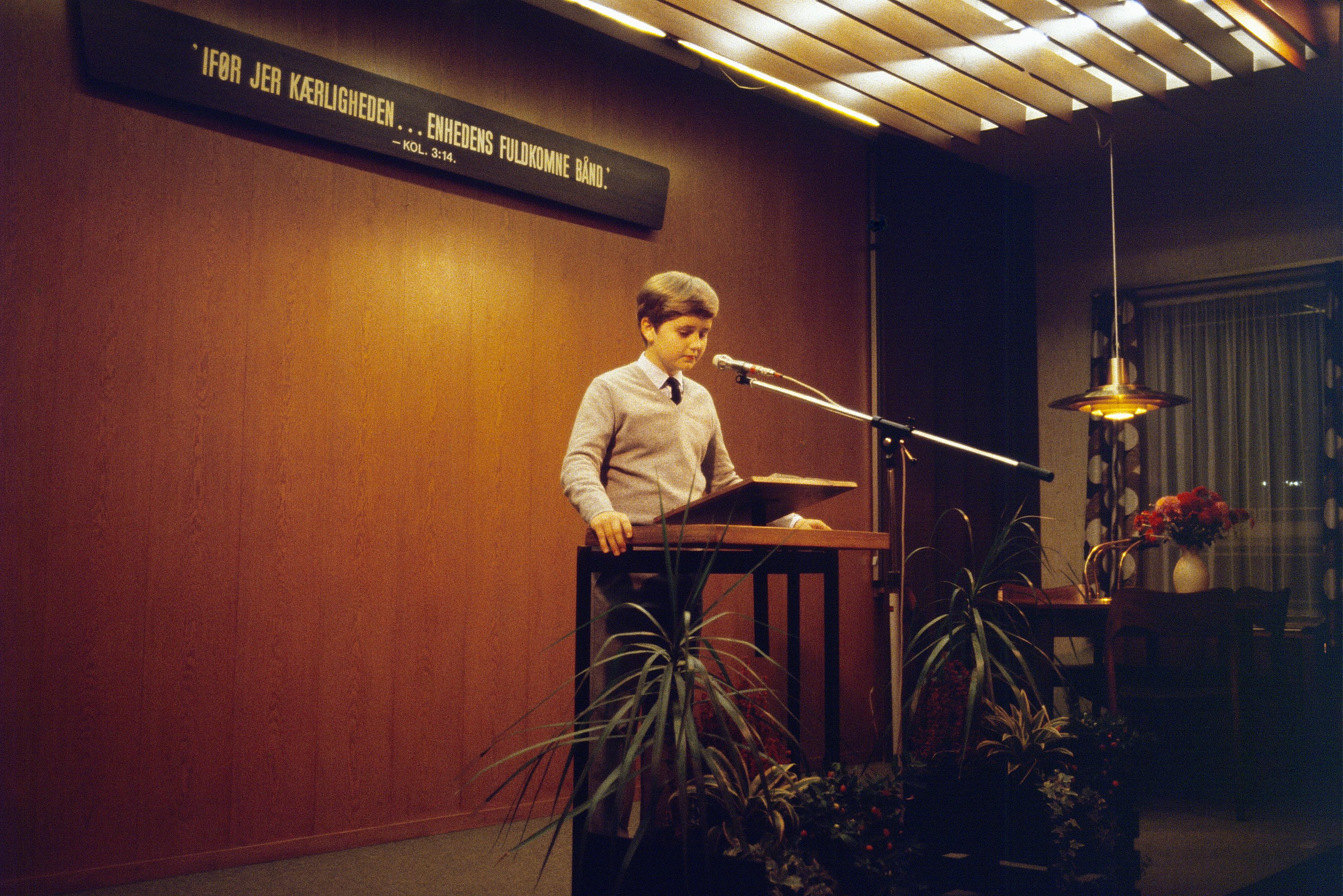 A young boy delivers a speech at a podium in Aarhus, Denmark.